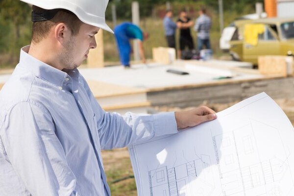 A foreman looking at construction staking