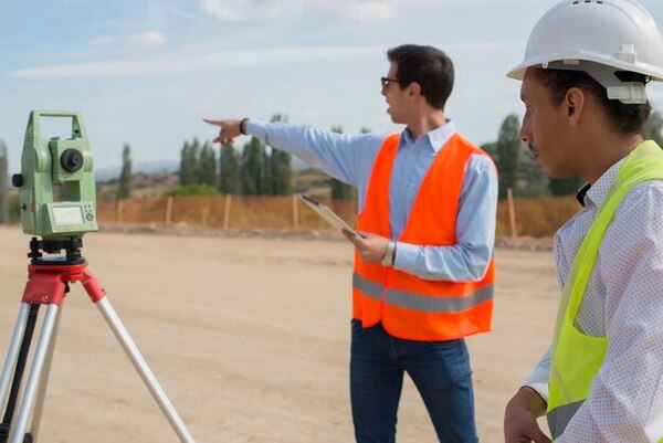 Survey technicians are performing construction site staking for a building project