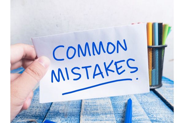 A person holding a paper with the word mistakes as a concept of a bad building layout